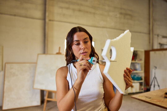 Woman creating artistic design in workshop space