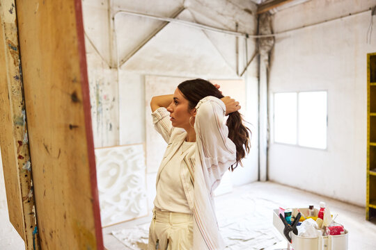 Creative artist preparing workspace for painting session in stud