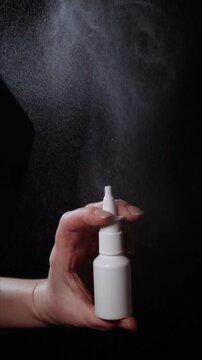 A hand holds a vasoconstrictor spray, illustrating its application and vaporization. The focus is on understanding how this drug can lead to addiction and health risks.