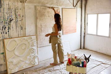 Artist creating abstract art in a bright studio space
