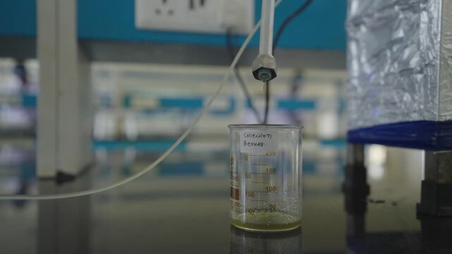 Laboratory Drip System Filling Collection Beaker Scientific Sample Collection in Research Laboratory