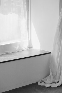 Soft white curtain with light near modern window ledge