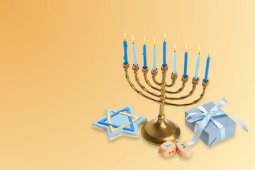 Hanukkah menorah with candles, star of David, dreidels, and gift box