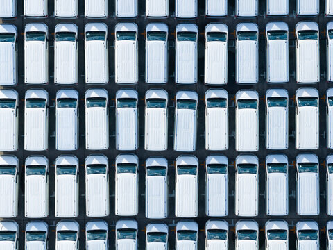 Aerial View of Neatly Arranged White Cars in Grid Pattern