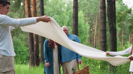siblings joyfully swinging white cloth in green forest while parents watch with smiles, sunlight dancing through trees creating warm family atmosphere filled with love, and peaceful summer energy