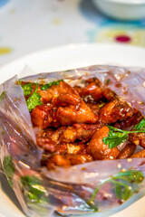 Sweet and rich flavor of paper-wrapped pork ribs, a traditional dish from Guangxi, China