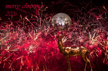 Copper-plated shiny deer mirror disco ball on horns - Christmas decoration on abstract background 2026 fireworks in the background