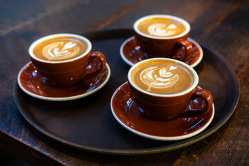 Three cups of hot caffe latte coffee at a specialty coffee shop