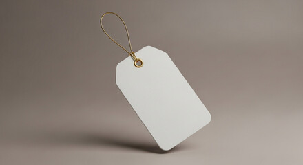 Fototapeta premium Blank price tag hanging against neutral background 