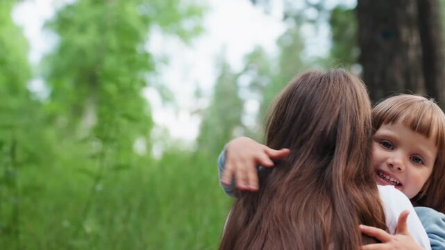 happy playmates sharing warm hug during picnic day surrounded by lush green forest, smiling brightly while enjoying peaceful outdoor moment filled with love, friendship, and childhood innocence