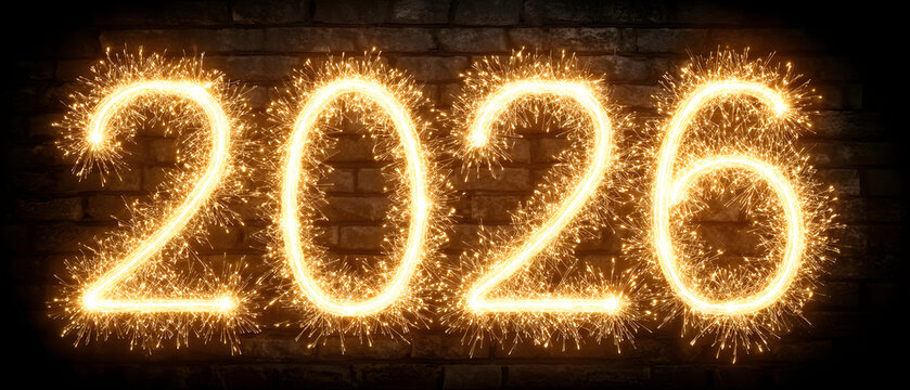 We wish you a Happy New Year 2026 light white yellow glitter typography with neon outline. New Year 2026 on yellow orange background