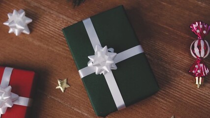 Wrapped gifts and holiday decor on a wooden surface, celebration items arranged, festive atmosphere