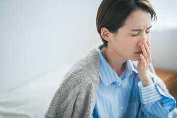 体調不良の女性