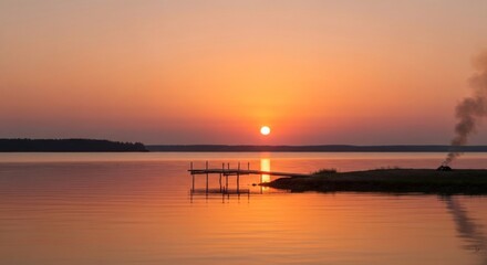 Obraz premium Serene sunset over a lake with a small dock and smoke