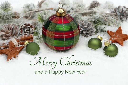 Christmas card: Christmas decoration with fir branches on a wintery background with the text Merry Christmas and a Happy New Year. - Powered by Adobe
