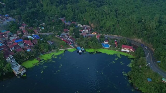 A rising pull-out aerial of dense tropical forest and winding hillside road in Talisay, Batangas, Philippines