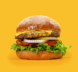 Classic gourmet beef burger with melted cheese and yellow sauce, topped with fresh onions and tomatoes on a vibrant yellow background