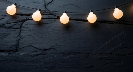 String lights glowing against dark stone wall for a festive atmosphere