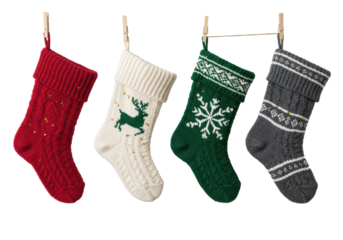 Four detailed, chunky woolen christmas stockings (red, green, white, gray) hanging on a jute line against a transparent backdrop with copy space, high-key studio photo. Concept of cozy tradition