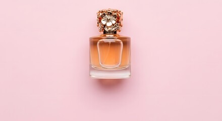 Elegant perfume bottle with ornate gold cap on soft pink background