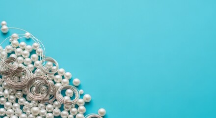 Elegant pearl necklace and silver jewelry on a bright blue background