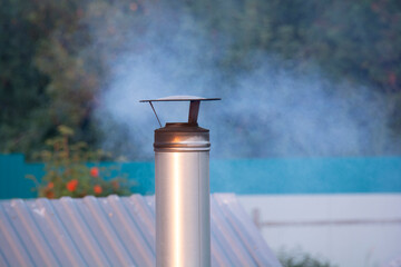 Chimney on the roof with smoke coming from it