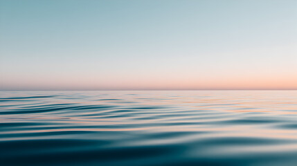 Obraz premium Serene Ocean Horizon: Gentle waves of the vast ocean stretch towards a pastel-colored sky, creating a sense of calm and tranquility in a visually minimalist composition.