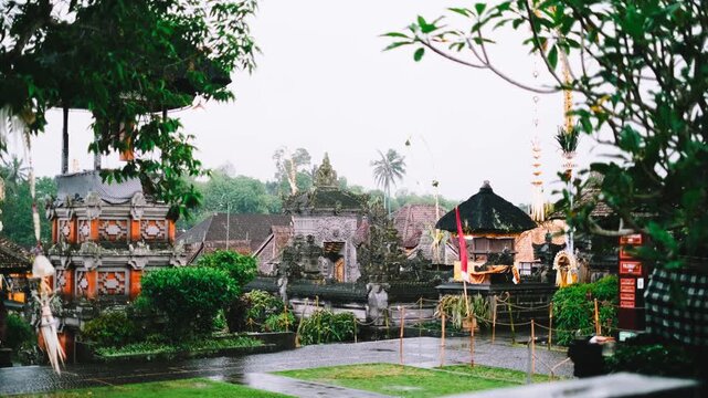 Penglipuran Village architecture and penjor during Galungan rain