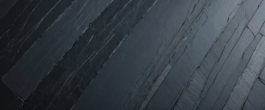 Dark gray natural slate background texture featuring diagonal stone patterns and rough fractured edges