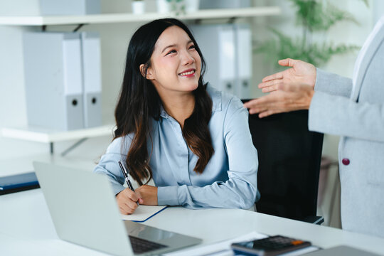 Asian senior businesswoman working with colleague working together