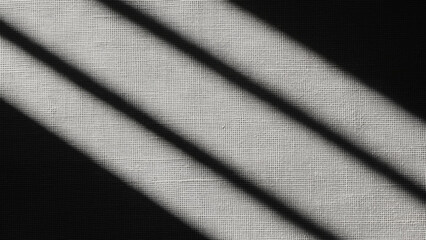 Natural light with shadow stripes on white textured surface. Abstract background with sunlight and dark contrast space for design.
