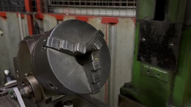 Close up view of a three jaw chuck an essential component of machine tools in an industrial workshop setting