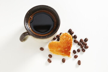 Coffee and toast with heart shape cutout