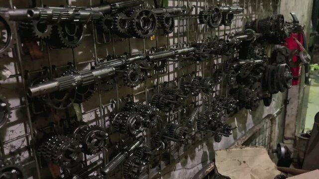 Close Up of metal gears and various transmission shafts displayed in a spare parts shop. Motorcycle Engine Parts