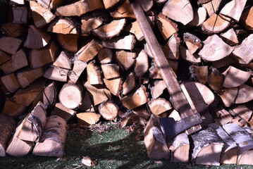 Axe leaning against a stack of firewood