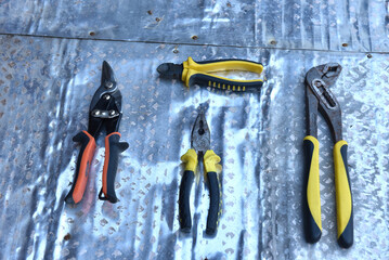 Metal hand tools on a metal surface