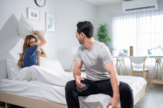 Stressed woman and aggressive man couple screaming at each other in house. 
