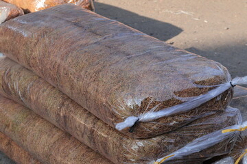 Stacked coir fiber material in plastic bags for export