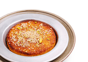 Delicious dessert featuring traditional kunafa topped with nuts and syrup