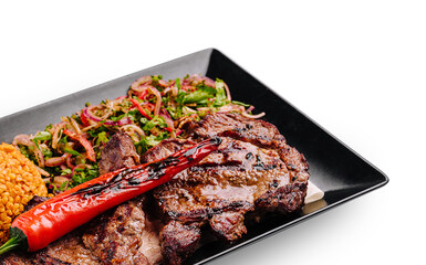 Delicious grilled steak served with roasted vegetables and lentils