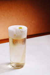 Refreshing drink with flower garnish served on a simple table