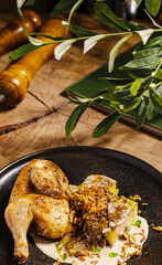 Delicious roasted chicken served with flavorful sauce and sides on wooden table