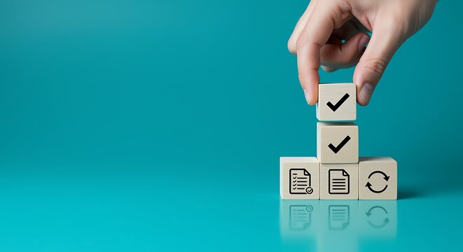 Hand placing a wooden block with a checkmark onto a stacked tower.