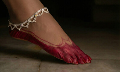 Traditional Bengali bride&rsquo;s foot decorated with alta and silver anklet