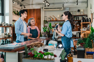 Asian Mother and Daughter Assist Male Customer at Ceramic Shop