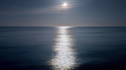 Fototapeta premium Photograph of a beautiful sunset over the ocean. the sky is a deep blue color with a few wispy clouds scattered across it.