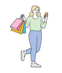 A woman is holding shopping bags and looking at her phone with a smile.