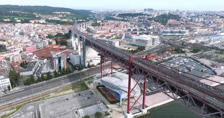 Half marathon and 10K long-distance running event in Lisbon, Portugal, Europe. Runners on the 25th April bridge running to the Águas Livres aqueduct. Alcantara, Monsanto park, aerial drone shot