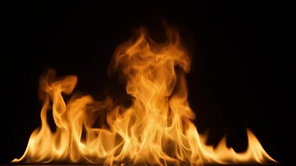 Flames flickering against dark background creating a fiery display for abstract themes, heat, energy, passion and burning concepts.