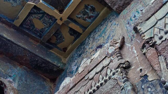 Giant Buddhist Guardian Warrior Sculpture Inside A Cave At The Maijishan Grottoes In Tianshui, Gansu Province, China. Tracking Shot